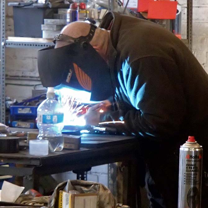 guy-welding-albion-bracket